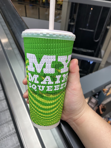 Hand holding a green Boost Juice cup